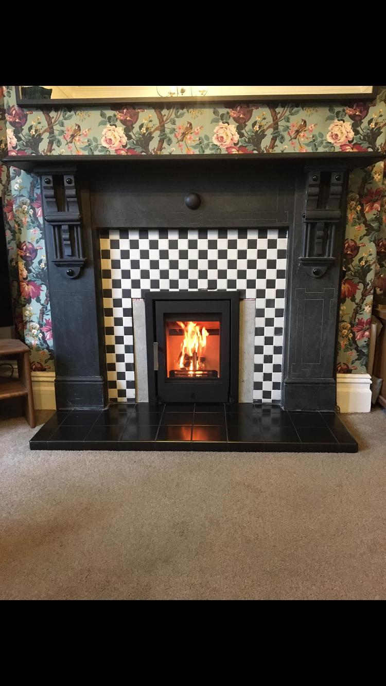 Inset stove with checkerboard tile surround