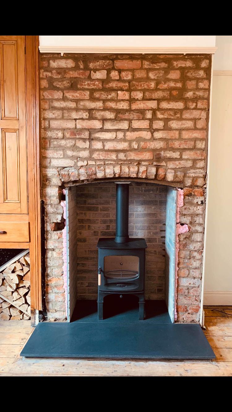 Stove installed in brick alcove