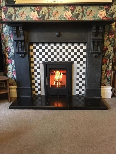 Inset stove with checkerboard tile surround