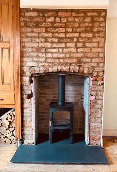 Stove installed in brick alcove