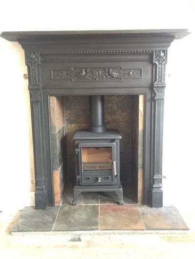 Stove in ornate cast iron fireplace surround